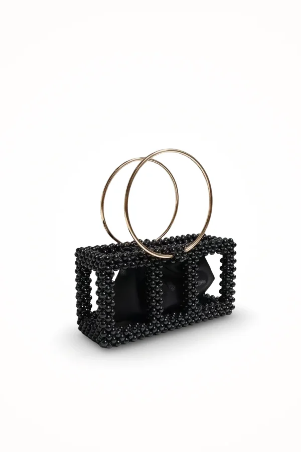 Glossy black beaded bag featuring gold handle and luxury design